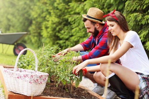 Gardening staff assessing a small Yeading front garden for pricing
